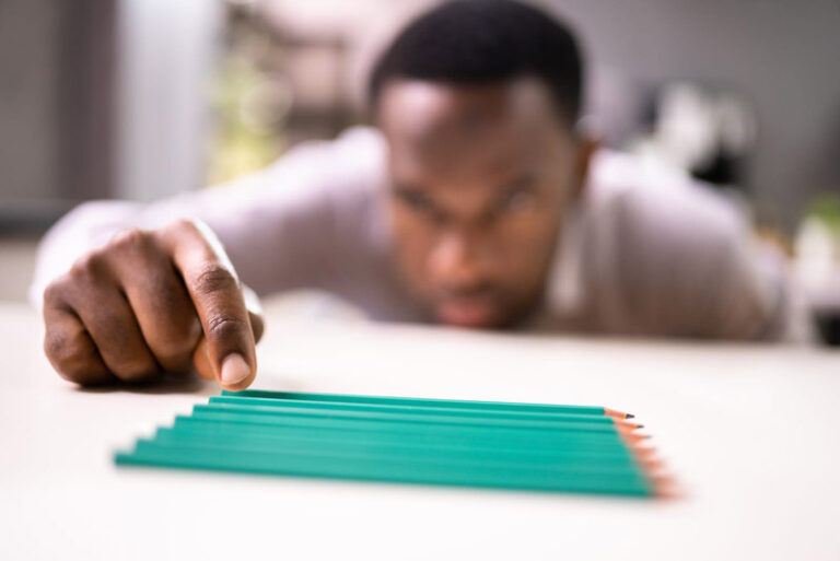 black man aligning pencils to be just right